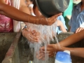 A group of children from a crèche wash their hands